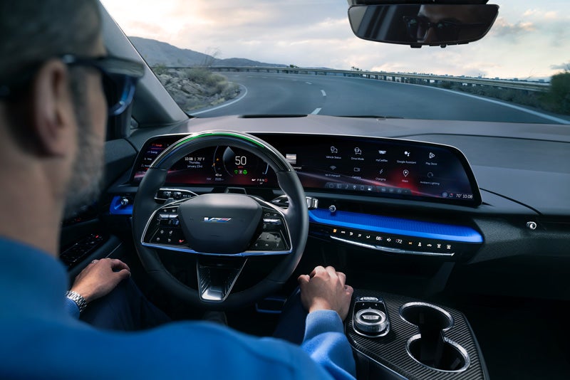 Front View of the 2026 OPTIQ-V Driving Through the Dusk Utilizing its Headlights | Marion Chevrolet Buick GMC Cadillac in Marion IL