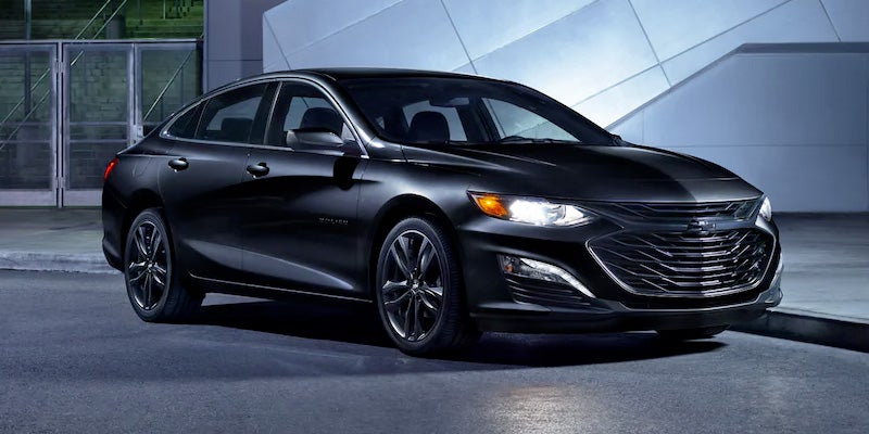 A black seaden car parked on internal building area road