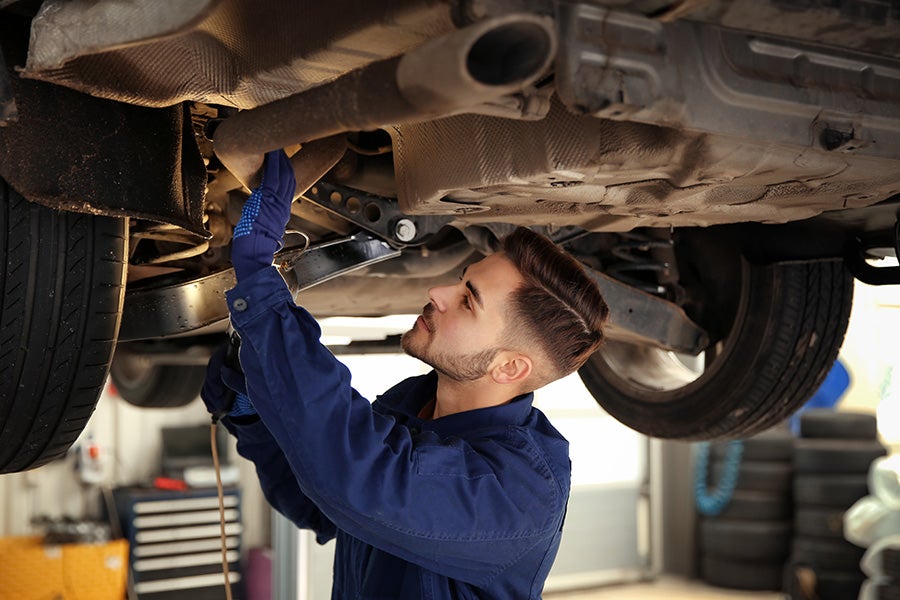 Car mechanic inspecting car engine